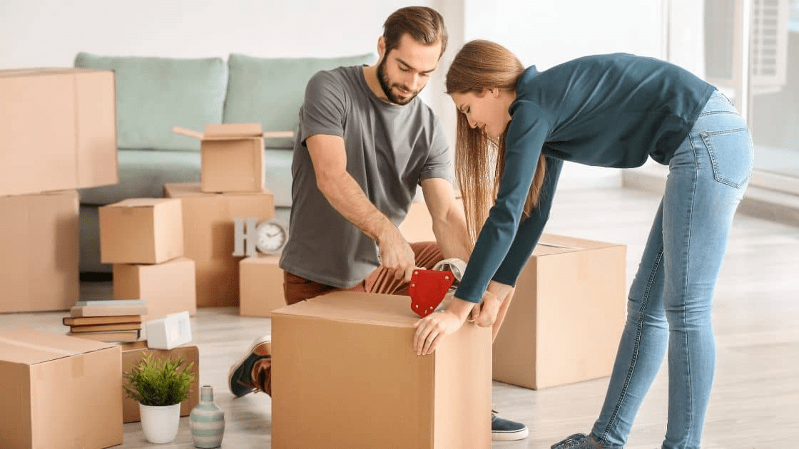 A couple packing boxes with packing materials and tape